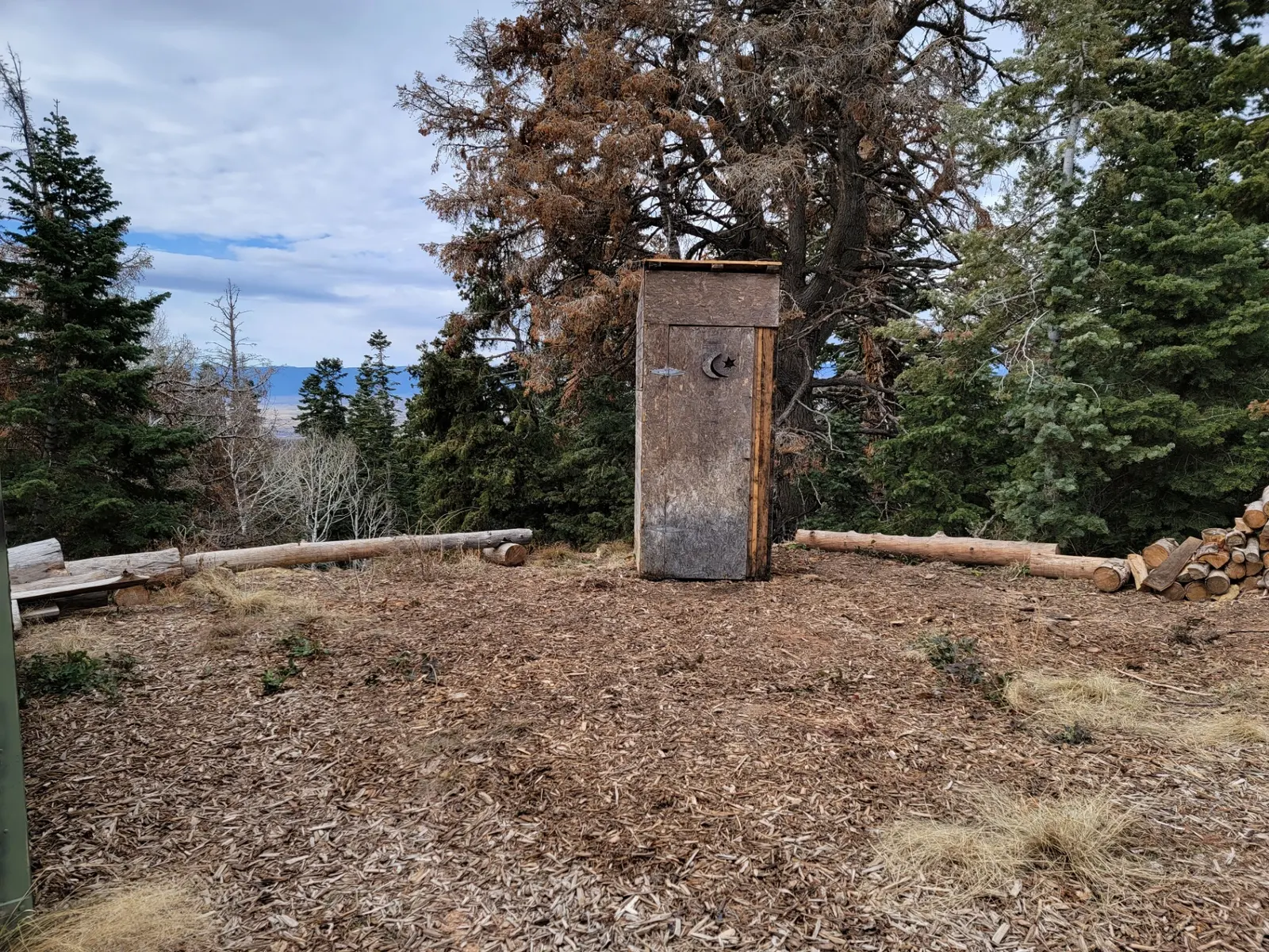 Mountain outhouse framed structure in natural setting