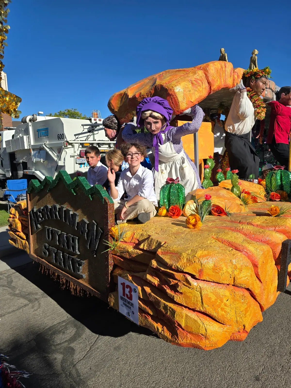 Finished parade float with participants in costume and temple structure
