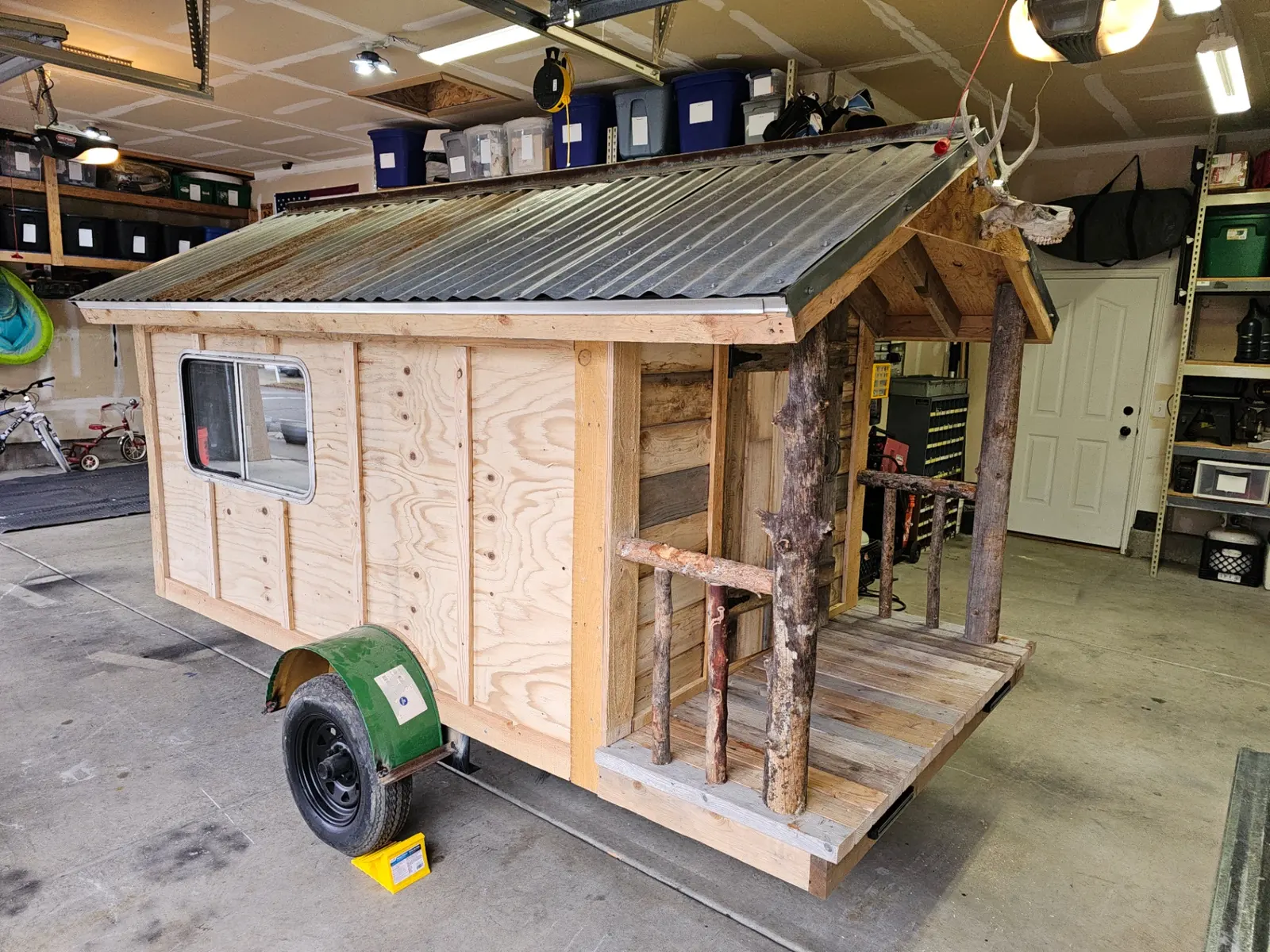 Cabin trailer with rustic porch and natural wood posts