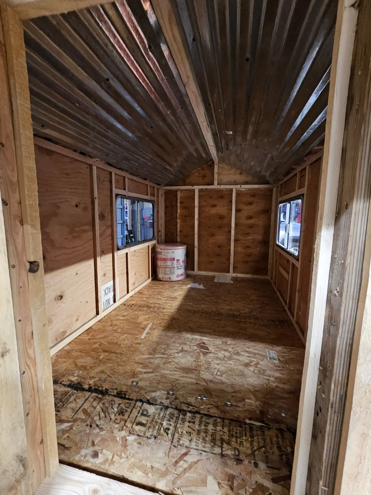 Interior construction showing wooden framing and plywood floor