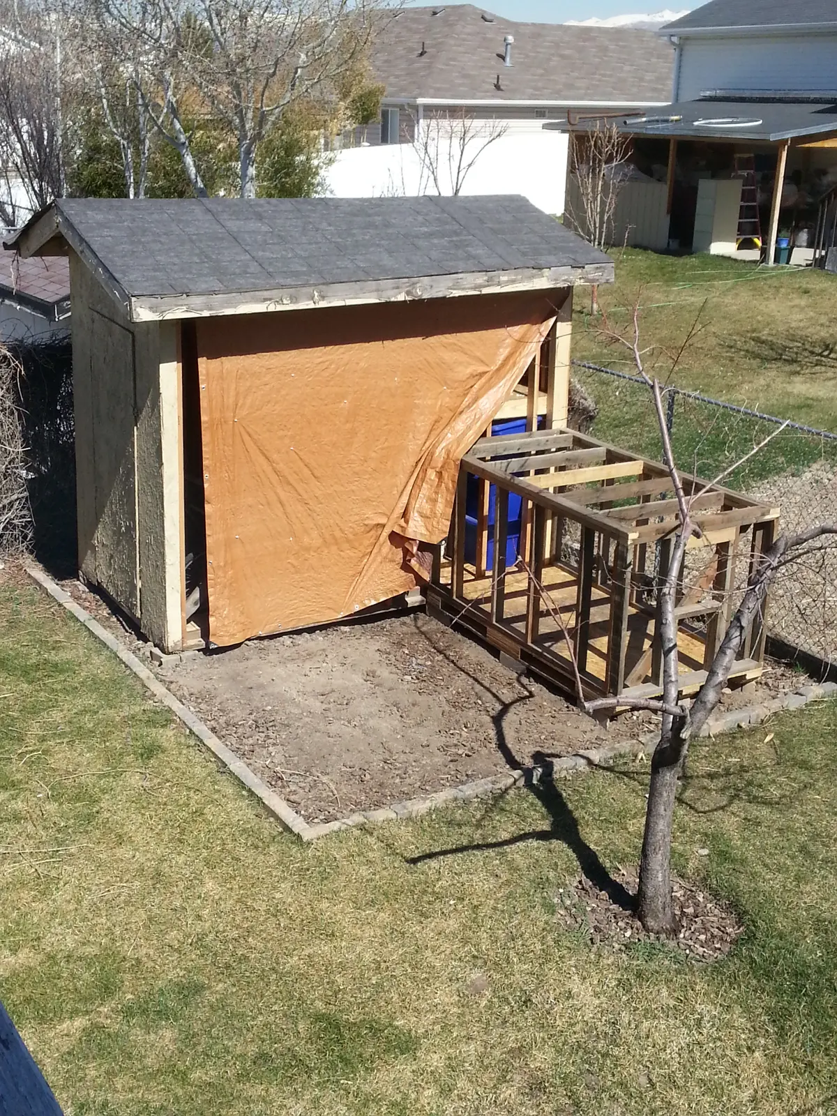 Western pallet playhouse mid-construction with covered roof section