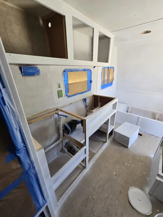 Freshly painted cabinet frames before the doors were fitted.