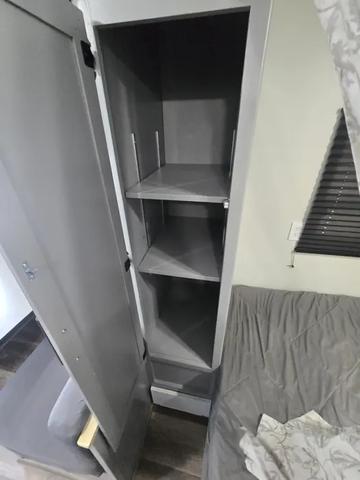 Finished wardrobe shelves beside the bed.