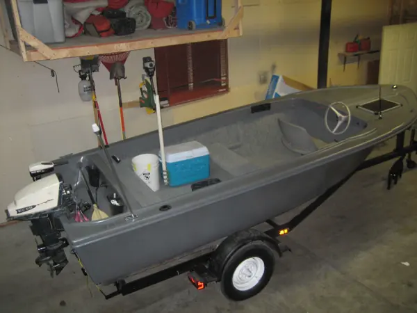Restored gray boat from above, showing the interior, seats and outboard motor