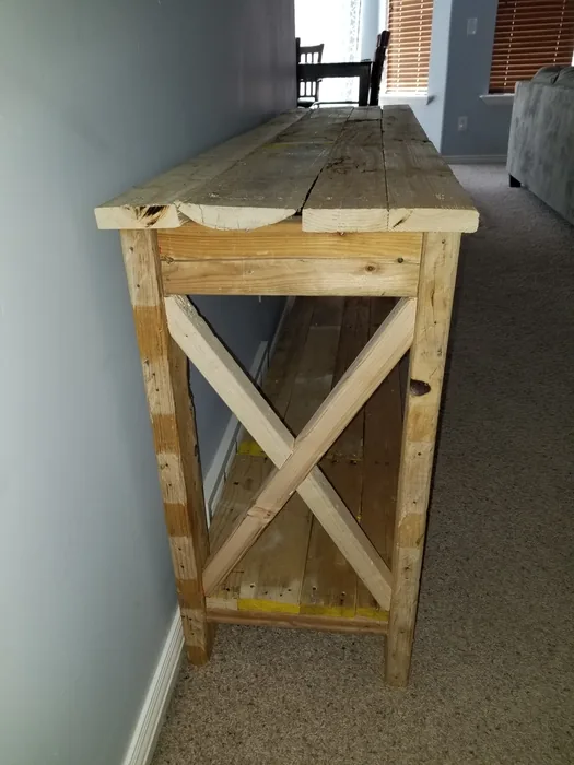 End view of the unpainted console table showing the cross-braced frame.