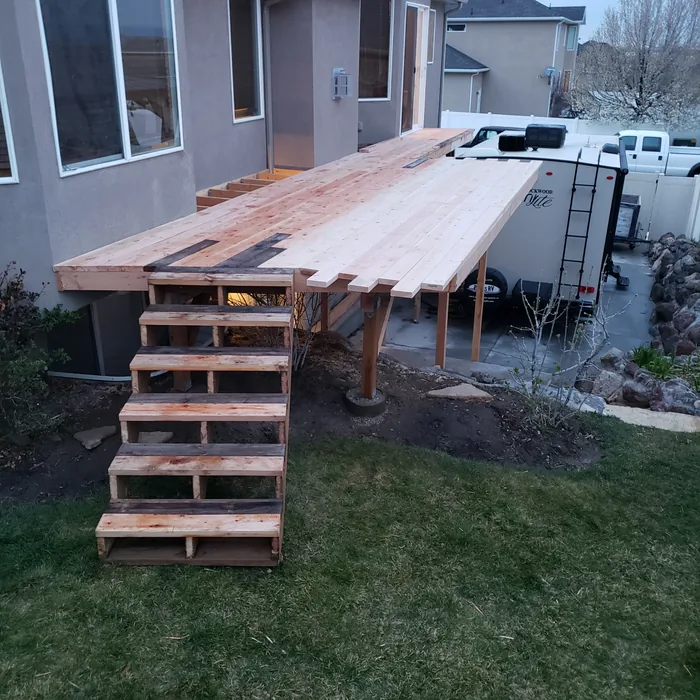 New deck boards and broad stairs installed before the railings.