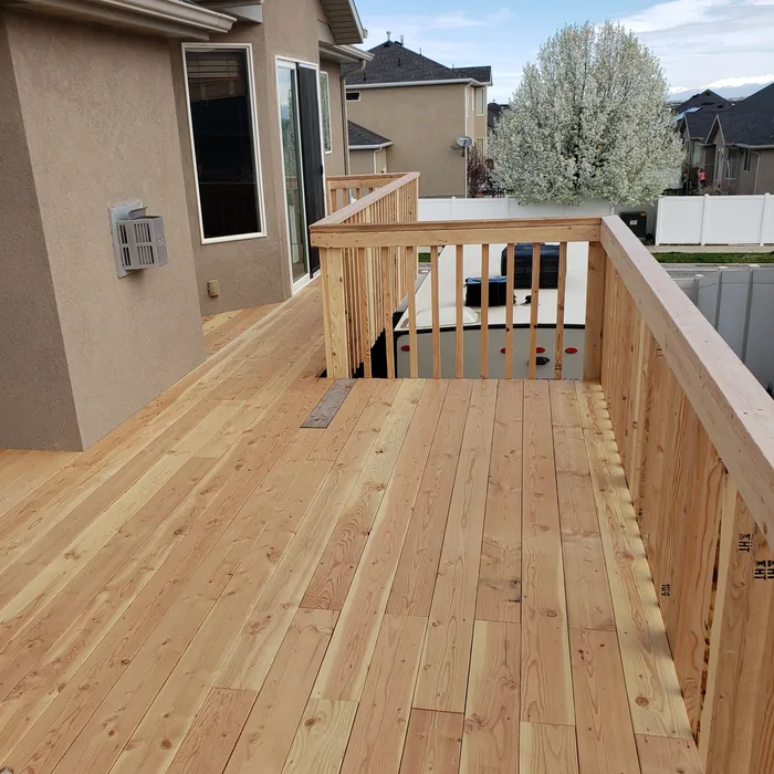 View along the completed wooden deck surface and railings.