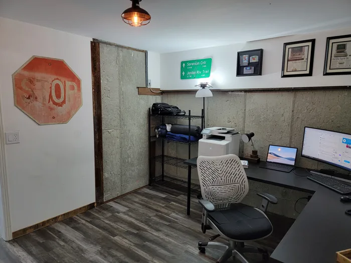 Opposite angle of the office showing the desk, seating and wall finishes.
