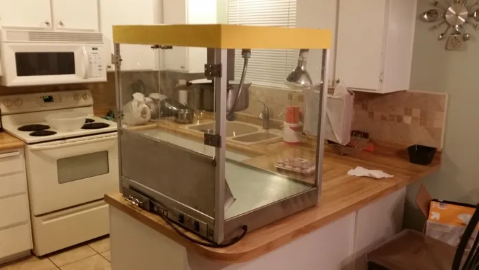 Reassembled popcorn machine from the opposite side, with kettle and clear glass panels