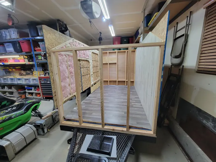 Flooring laid inside the open wall frame.