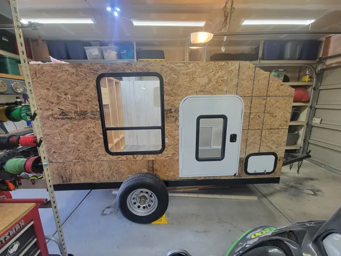 Exterior wall sheathing with the doors and window fitted.