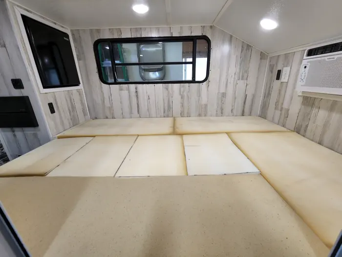 Foam cushions laid out as a bed.