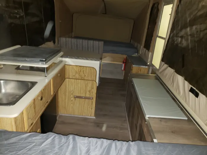 Finished popup interior with its galley, seating and sleeping area.