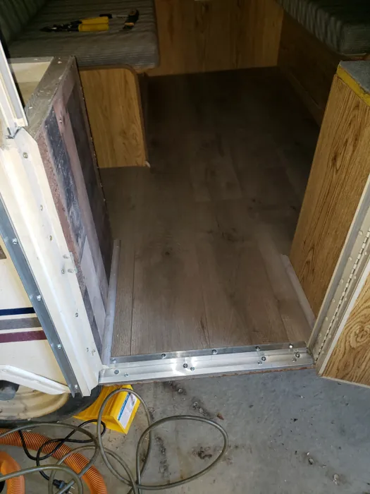New wood-look floor in place while the interior benches are being worked on.