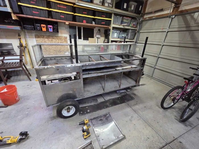 The stripped cart frame and cooking area during rebuilding.