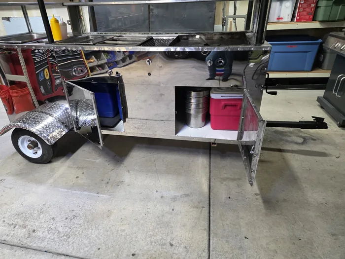 Restored cart with its storage compartments open beneath the serving surface.